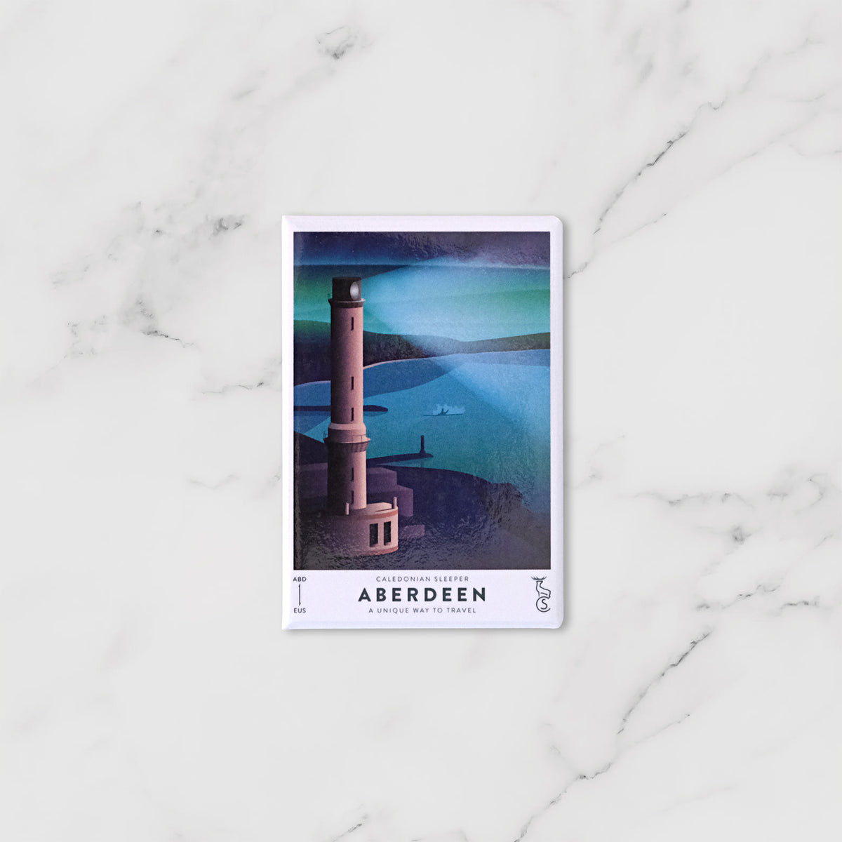 A rectangular Caledonian Sleeper fridge magnet featuring a lighthouse and coastal waters labelled 'Aberdeen' 
